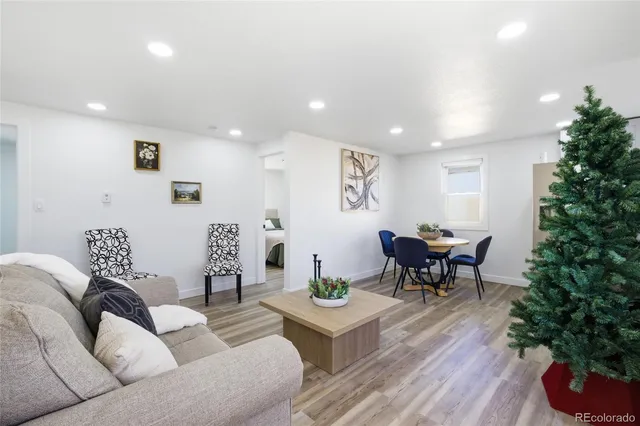 a living room with furniture and a potted plant