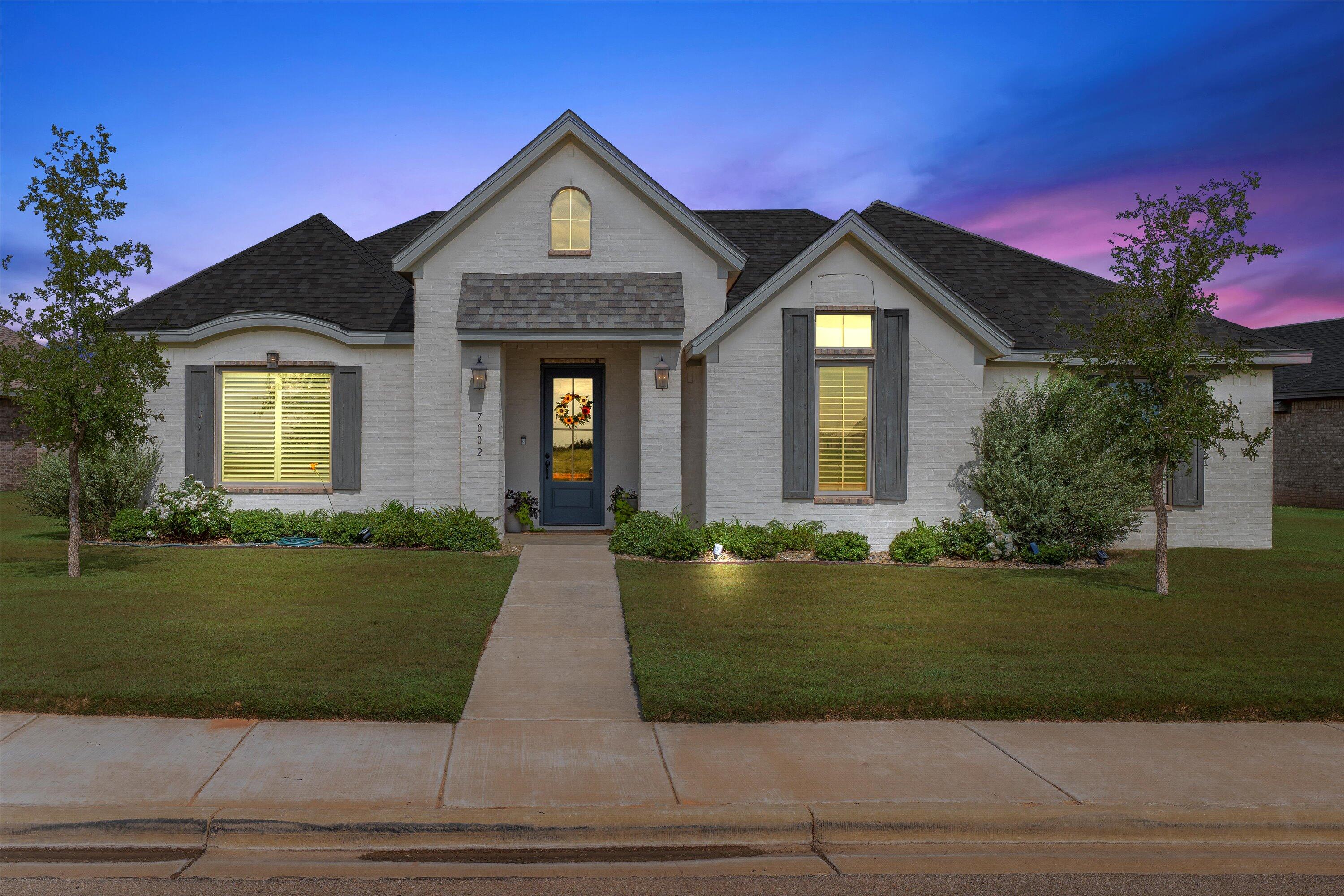 7002 103rd Street Lubbock, TX 79424 - Photo 1 of 35 a front view of a house with a yard