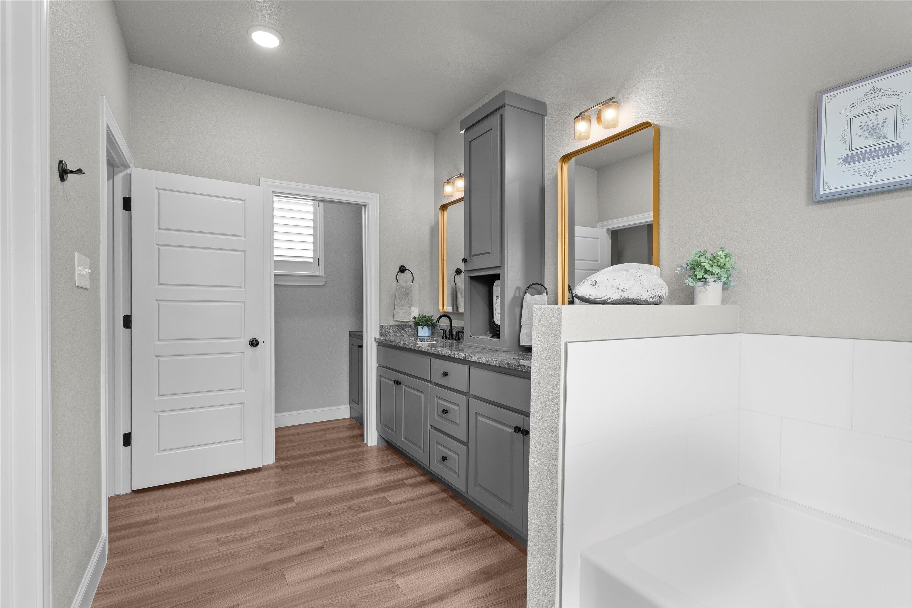 7002 103rd Street Lubbock, TX 79424 - Photo 18 of 35 a bathroom with a sink and a mirror