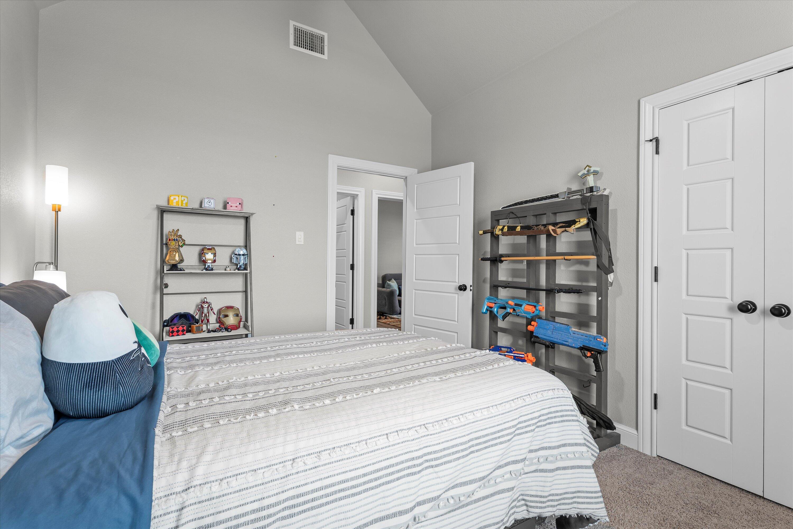 7002 103rd Street Lubbock, TX 79424 - Photo 21 of 35 a bedroom with a large bed and a wooden floor