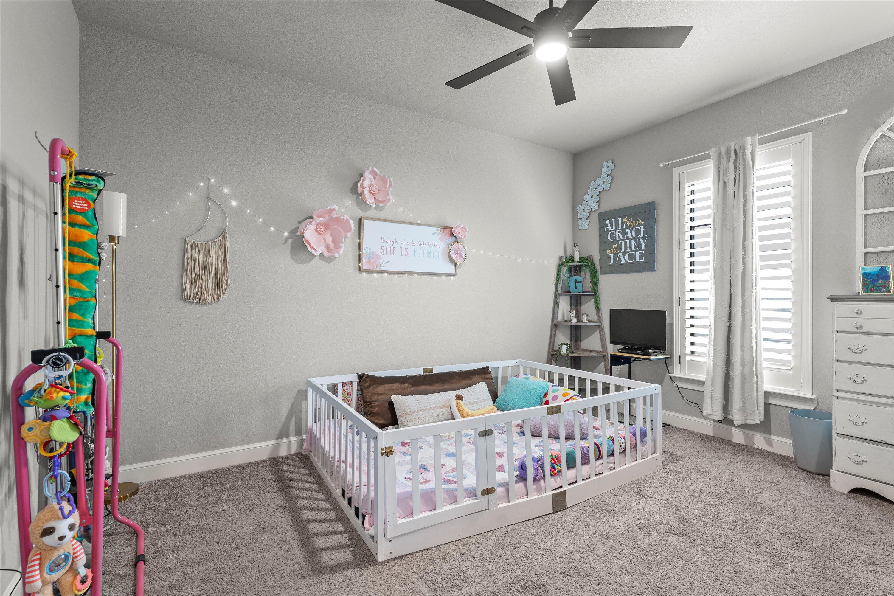 7002 103rd Street Lubbock, TX 79424 - Photo 23 of 35 a bedroom with furniture a rug and a bed