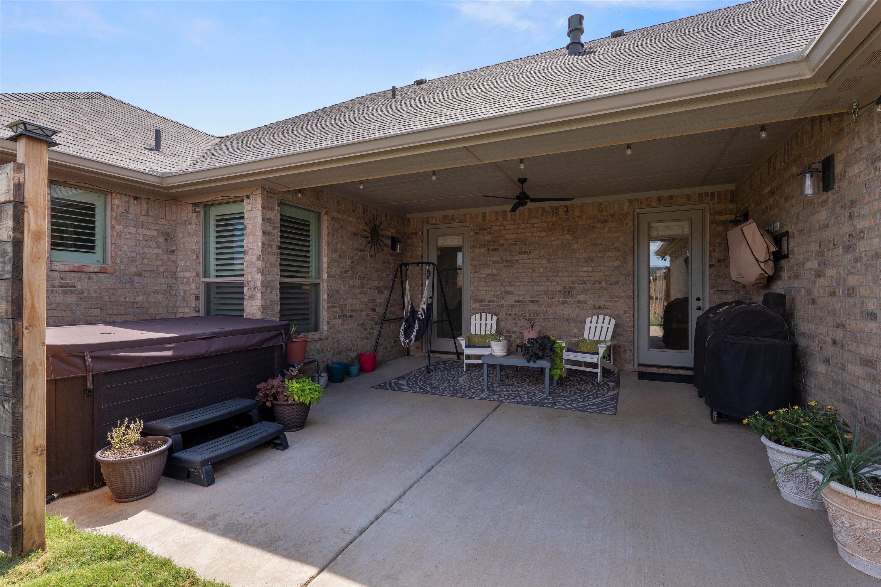 7002 103rd Street Lubbock, TX 79424 - Photo 29 of 35 a view of a patio with a table and chairs