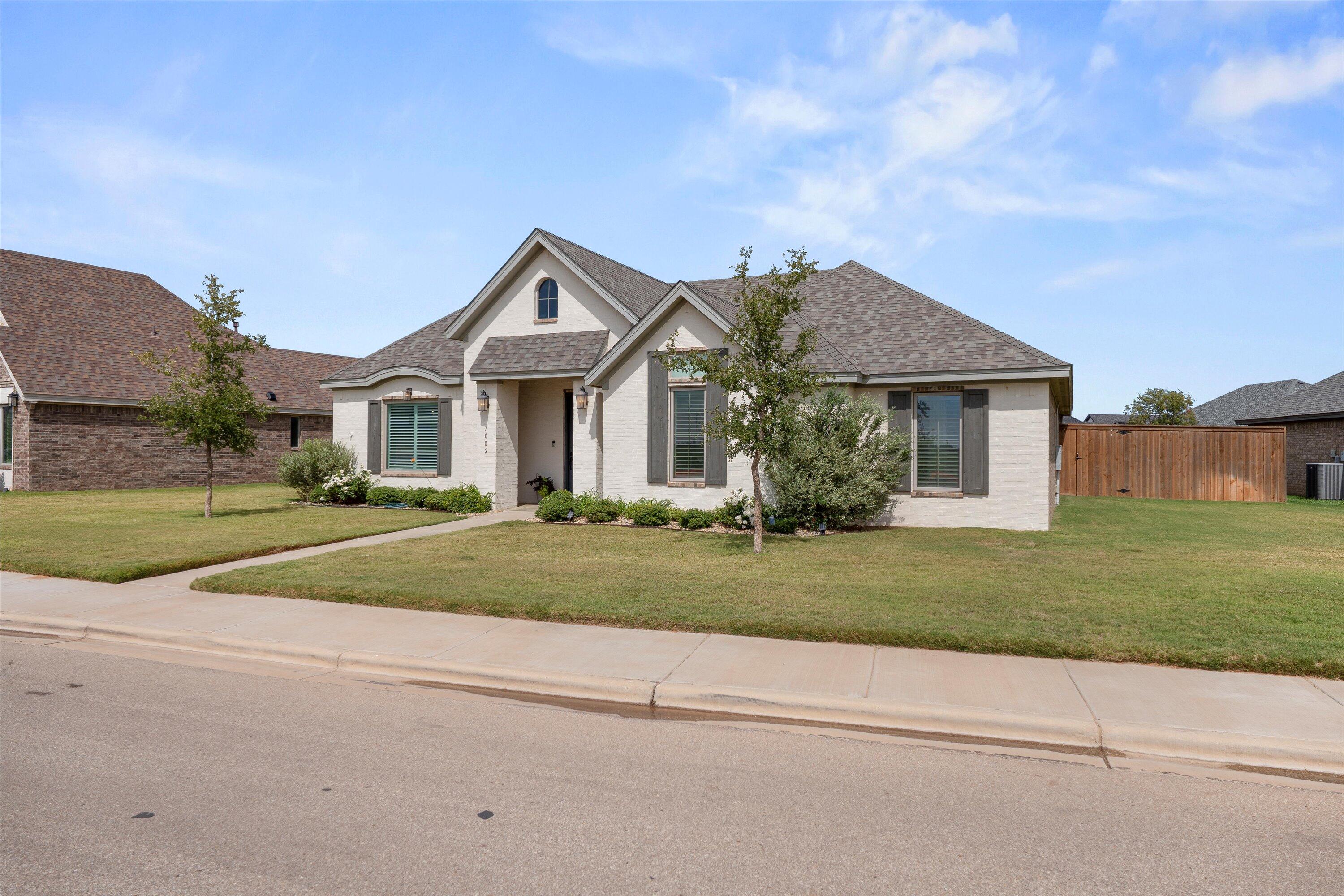 7002 103rd Street Lubbock, TX 79424 - Photo 3 of 35 a front view of a house with a yard