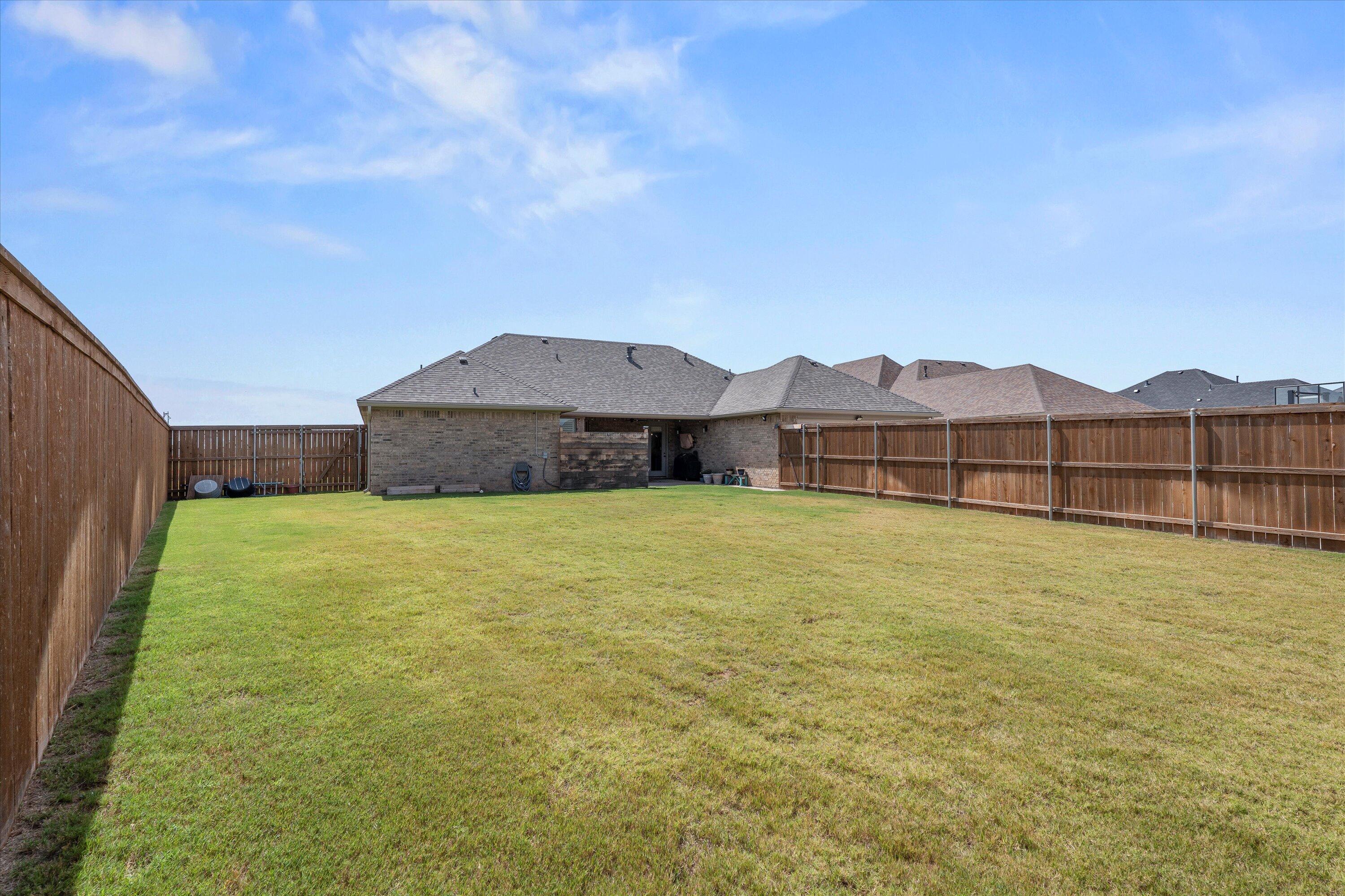 7002 103rd Street Lubbock, TX 79424 - Photo 33 of 35 a front view of a house with a yard
