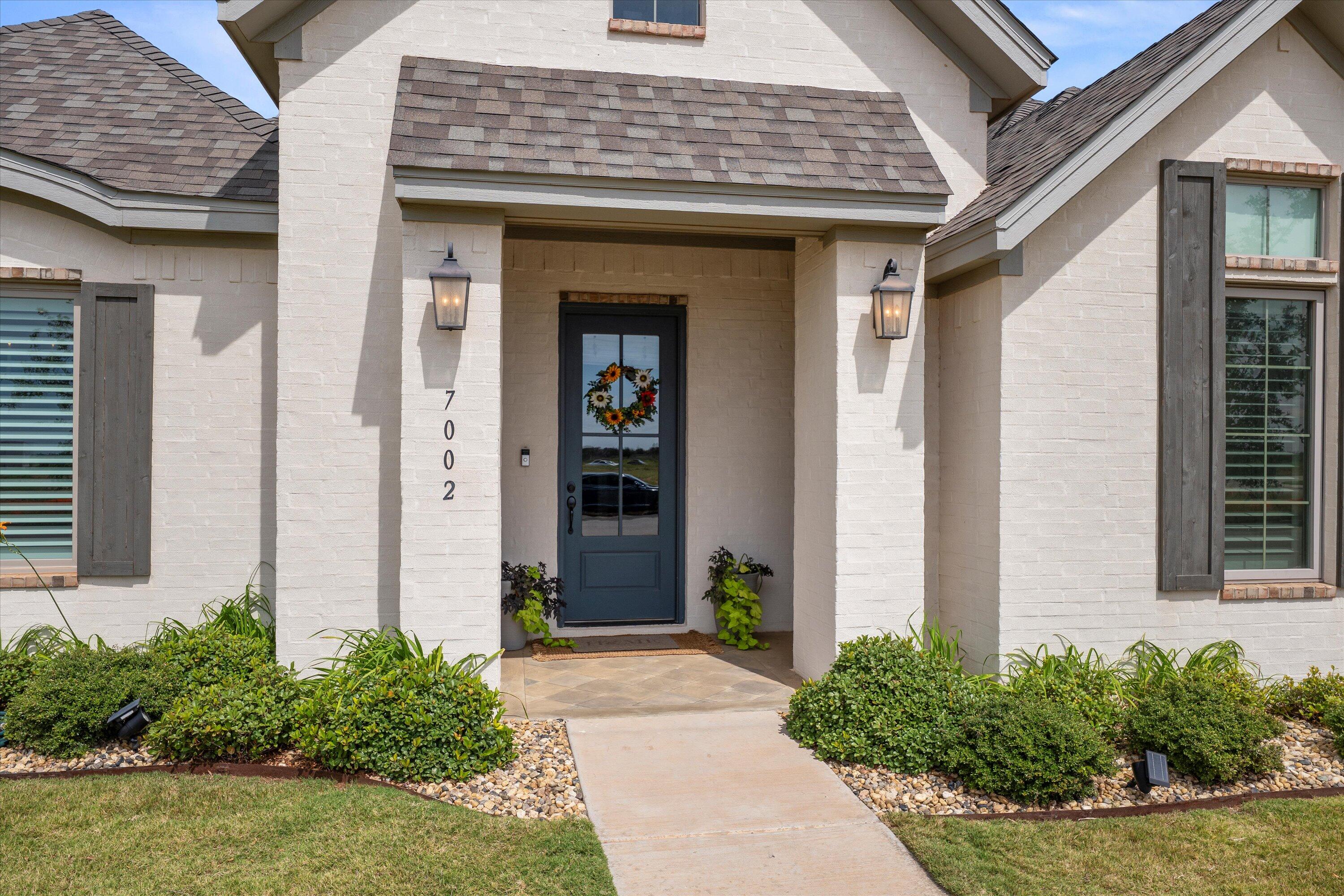 7002 103rd Street Lubbock, TX 79424 - Photo 4 of 35 a front view of a house with garden