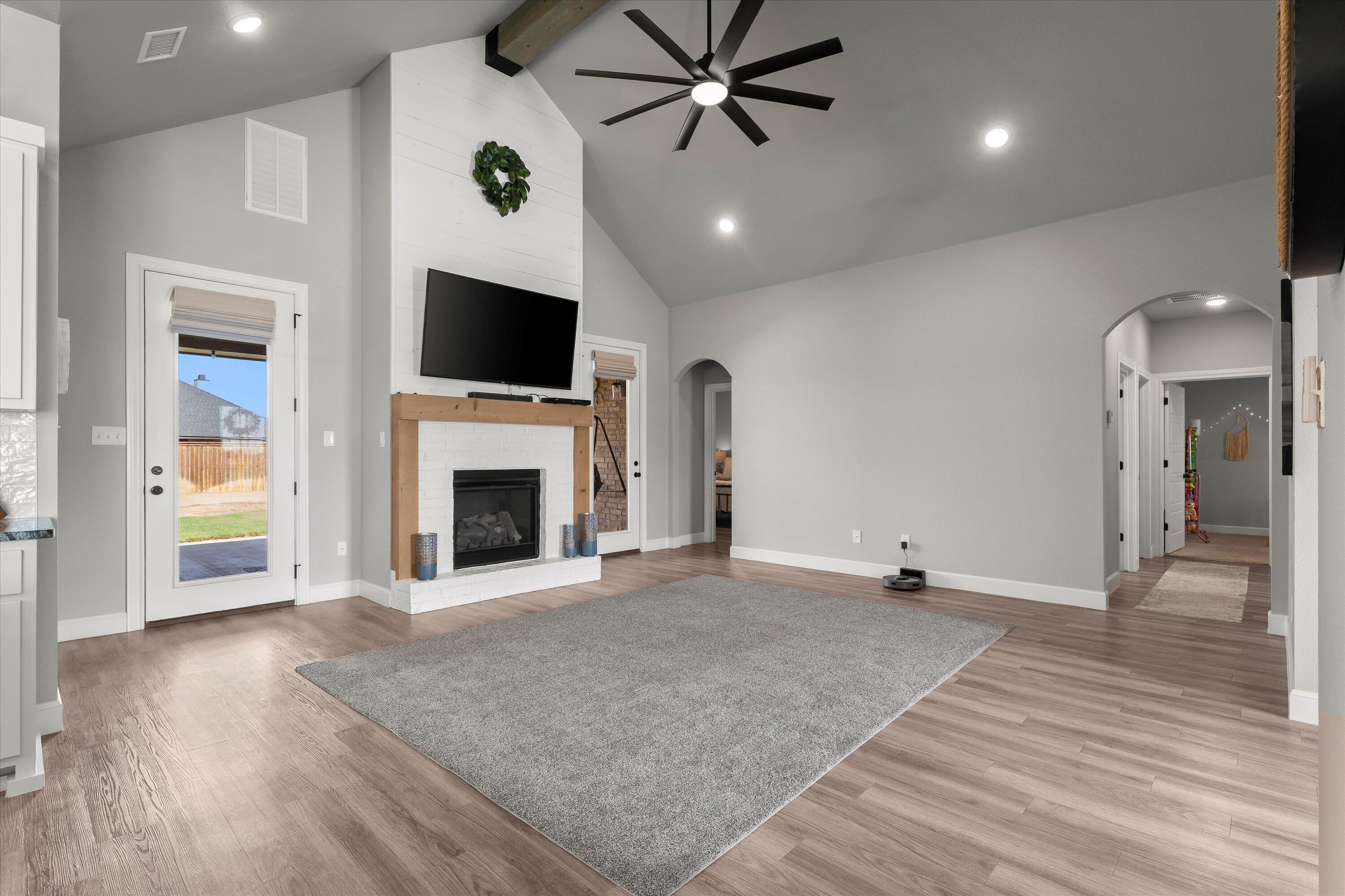 7002 103rd Street Lubbock, TX 79424 - Photo 9 of 35 a view of an empty room with a fireplace and a window