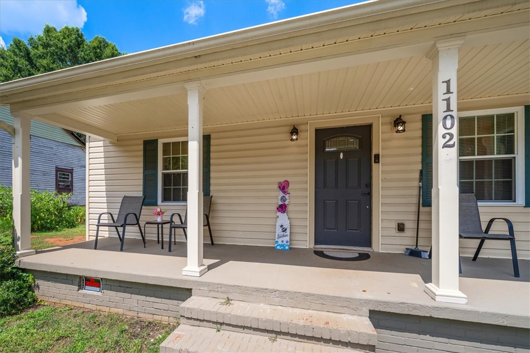 1102 West End Avenue Anderson, SC 29625 - Photo 3 of 28 A welcoming covered porch with ample space offers comfortable outdoor living.