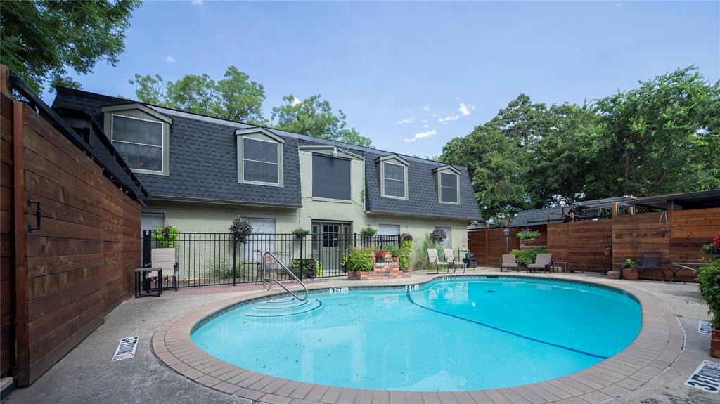 a view of a house with pool and chairs