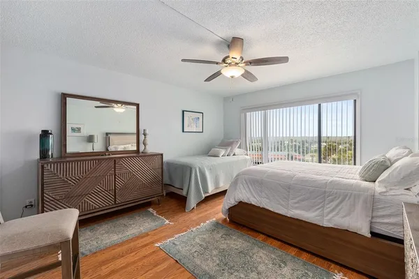 a bedroom with a large bed and a chandelier