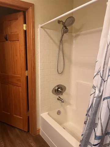 a bathroom with a shower and a tub