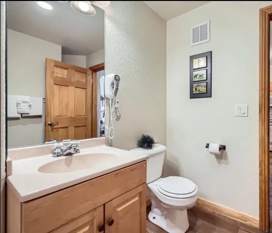 a bathroom with a sink toilet and mirror