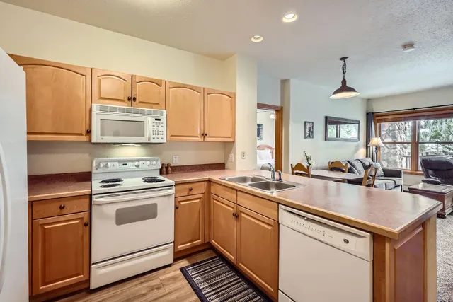a kitchen with stainless steel appliances granite countertop a sink stove and cabinets