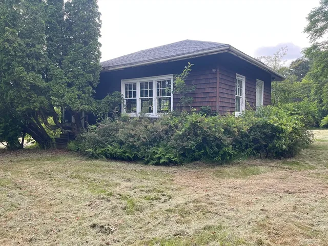 a view of a brick house with a yard