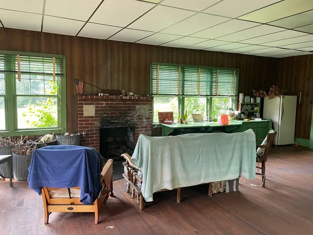 a living room with furniture a window and a fireplace