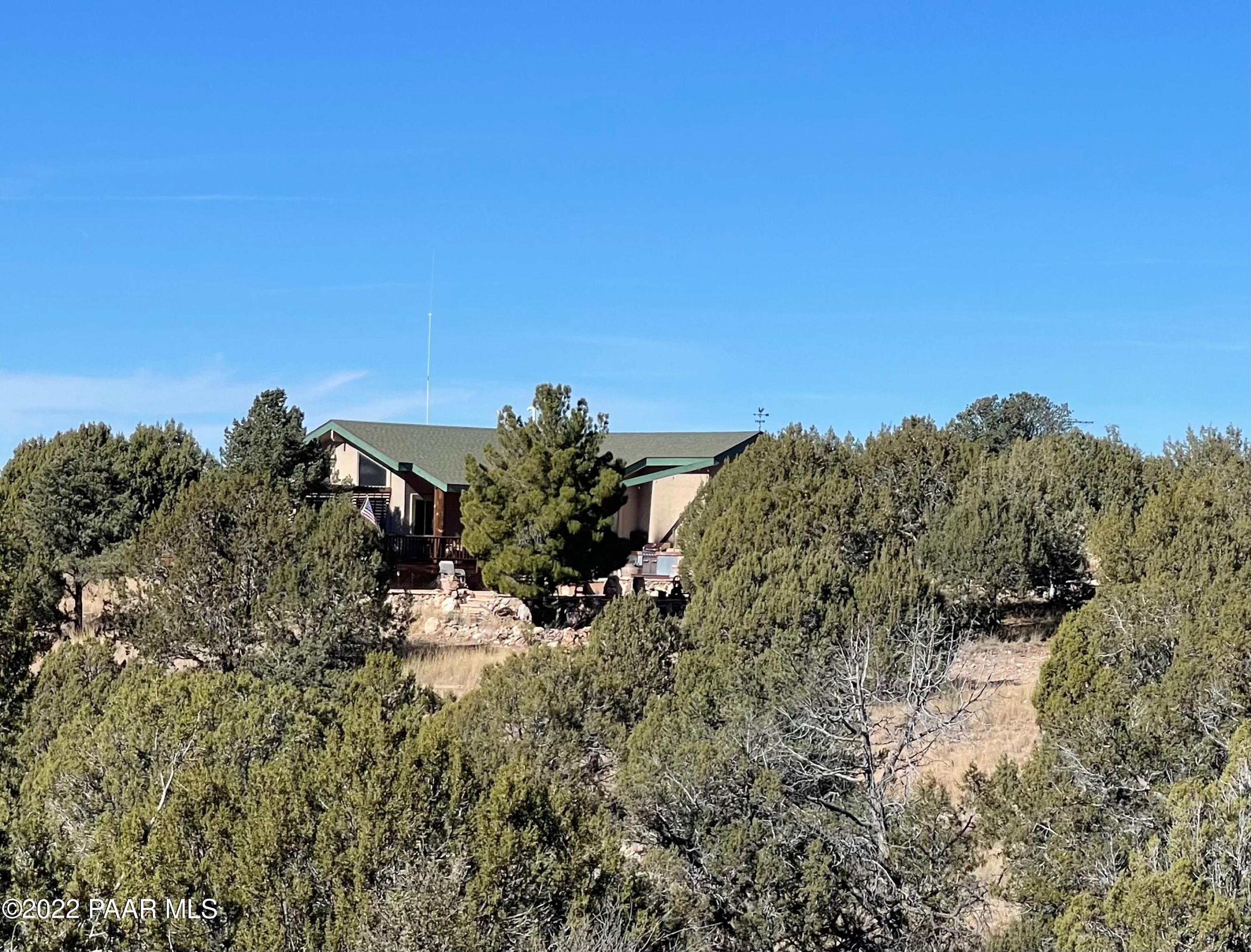 18100 Crossroads Ranch Road Prescott, AZ 86305 - Photo 1 of 40 a view of a house with a mountain in the background