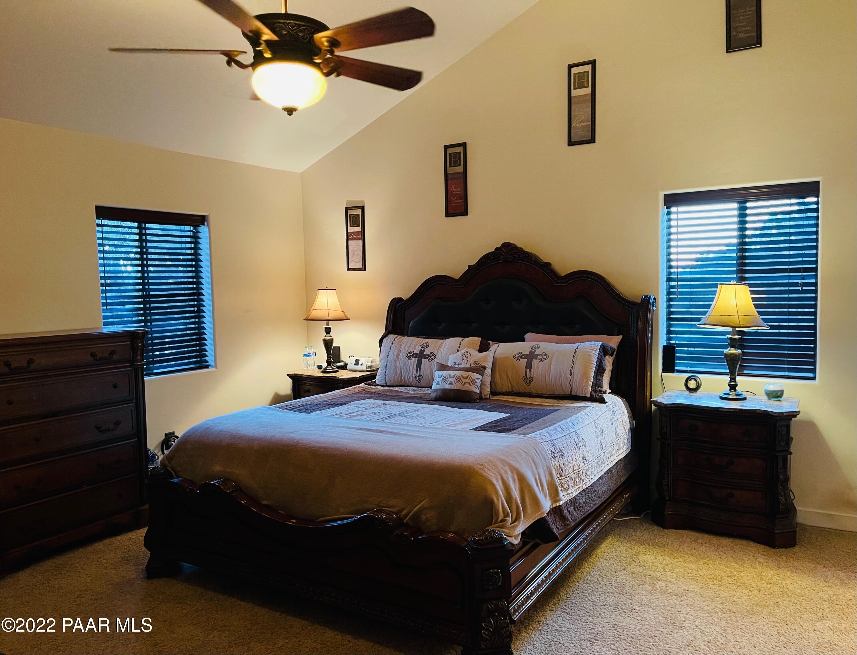 18100 Crossroads Ranch Road Prescott, AZ 86305 - Photo 12 of 40 a bedroom with a bed and a chandelier