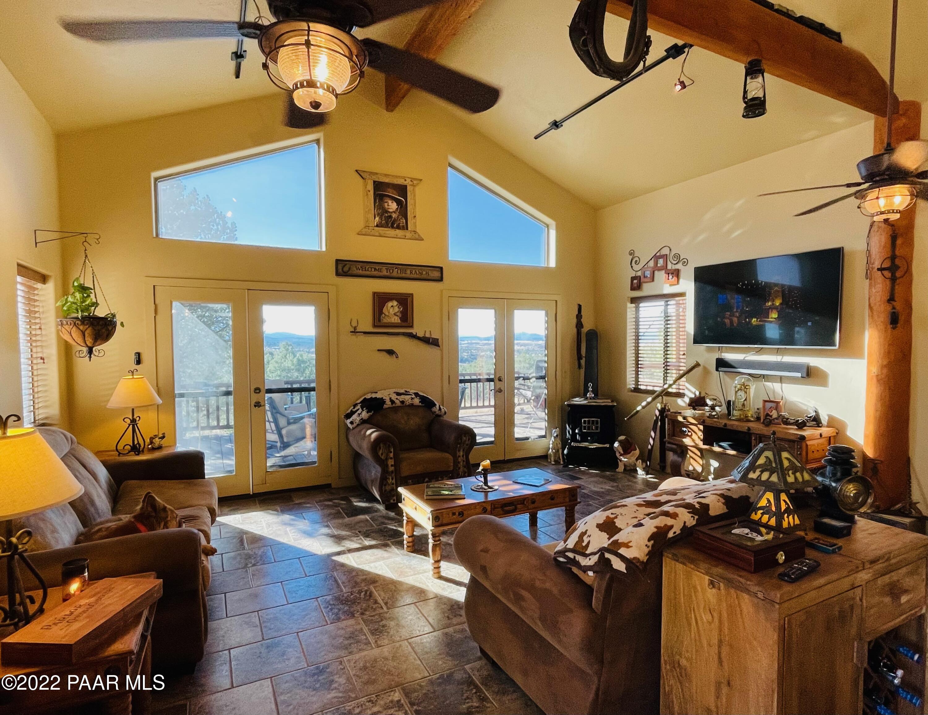 18100 Crossroads Ranch Road Prescott, AZ 86305 - Photo 5 of 40 a living room with furniture a flat screen tv and a window