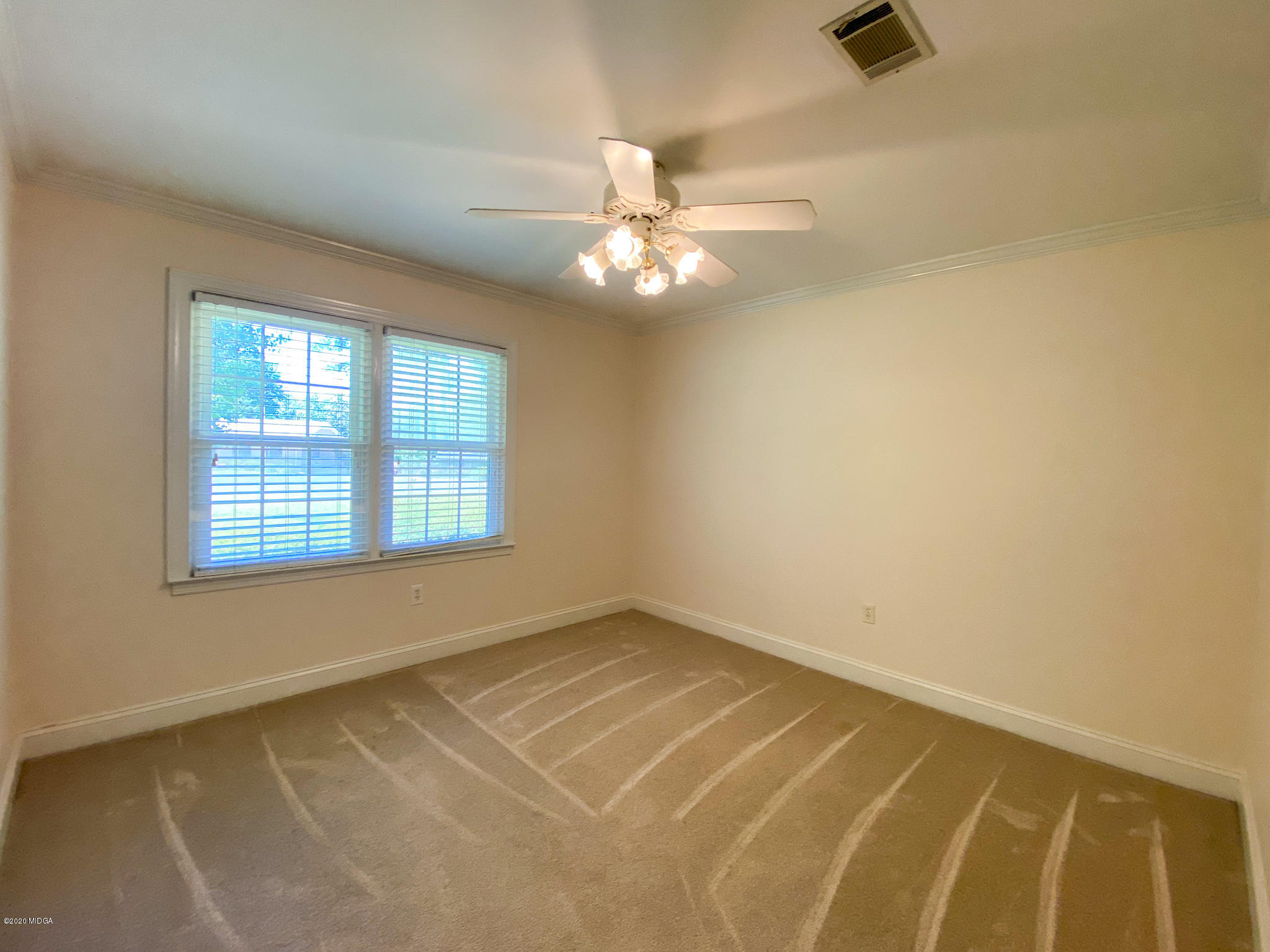 1800 Northside Road Perry, GA 31069 - Photo 22 of 39 an empty room with a window and a ceiling fan