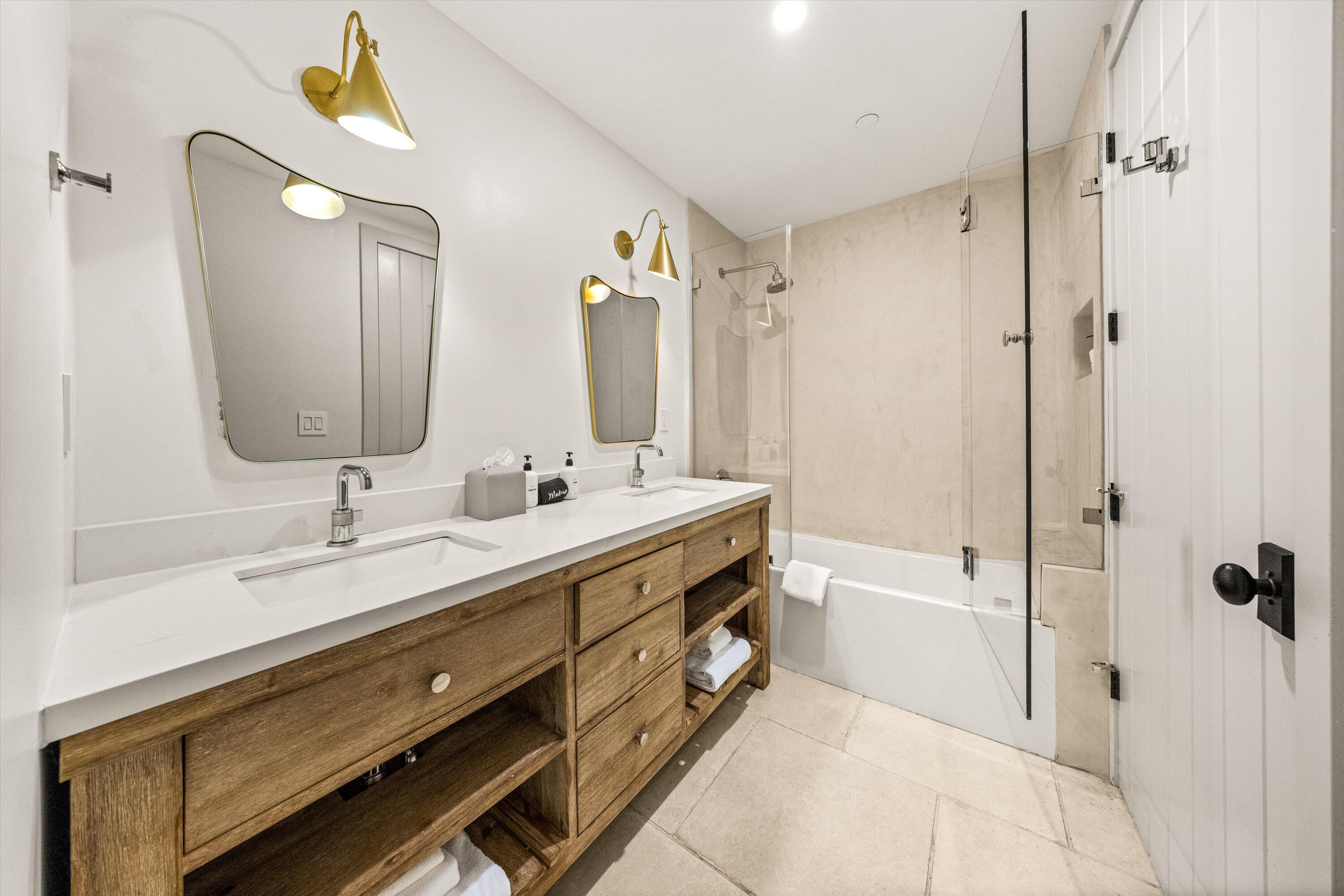 6 East Valerio Street Santa Barbara, CA 93101 - Photo 19 of 74 a spacious bathroom with a double vanity sink toilet mirror and bathtub