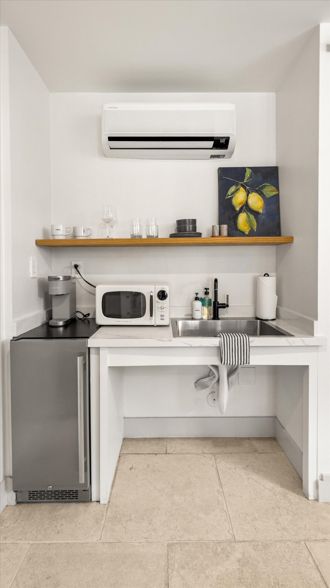 6 East Valerio Street Santa Barbara, CA 93101 - Photo 26 of 74 a view of white cabinets and a sink with wooden floor