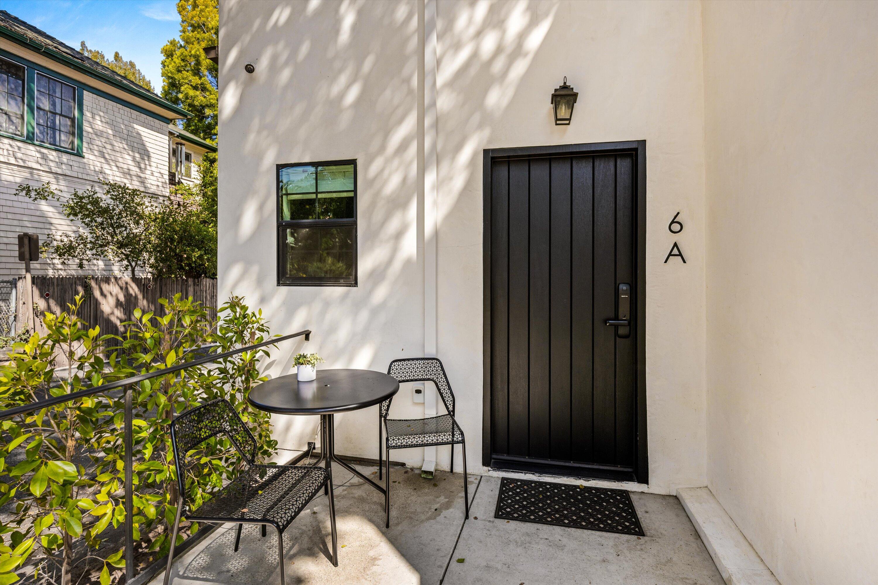 6 East Valerio Street Santa Barbara, CA 93101 - Photo 5 of 74 a front view of a house with a glass door and glass door