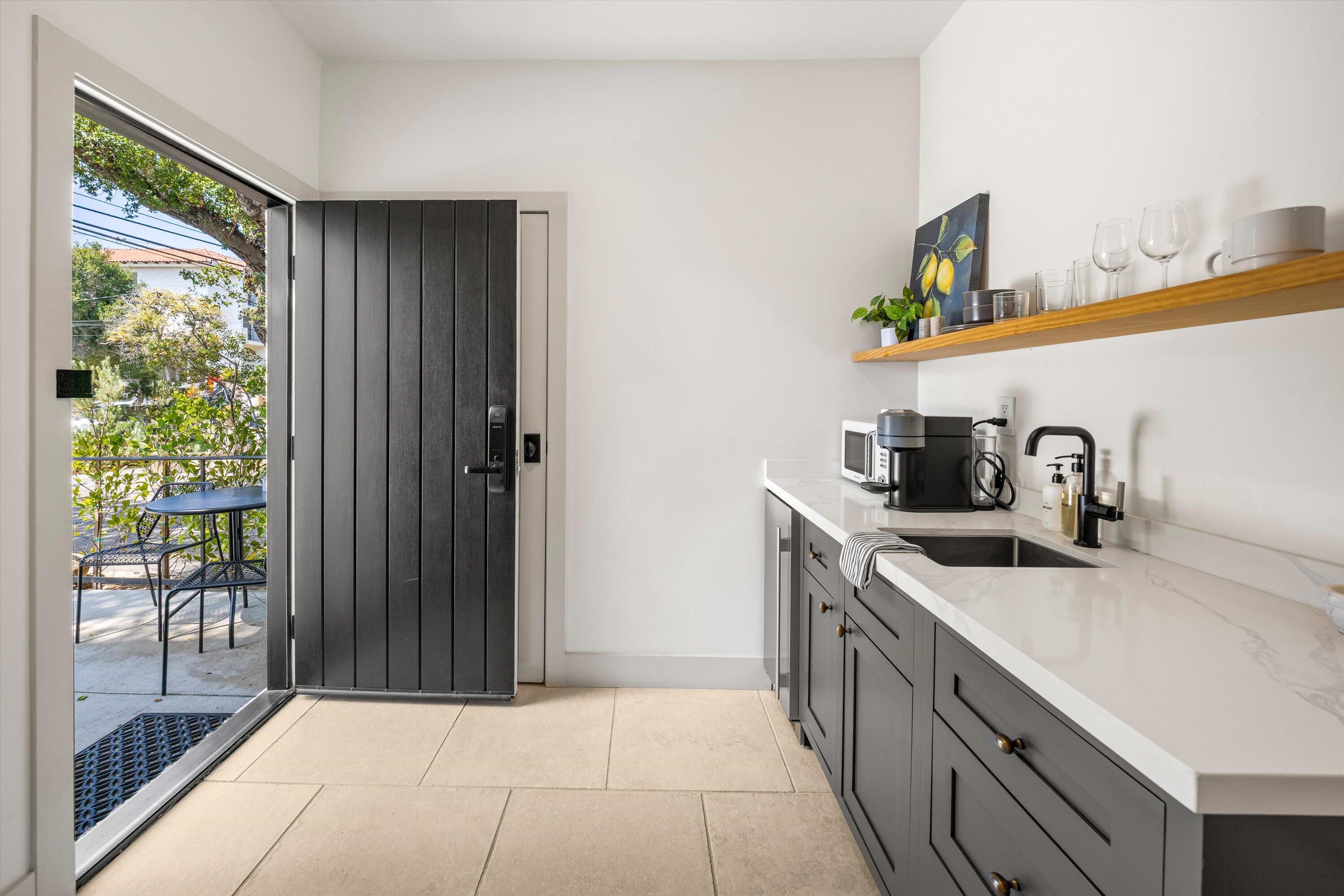 6 East Valerio Street Santa Barbara, CA 93101 - Photo 6 of 74 a kitchen with stainless steel appliances a sink stove and cabinets