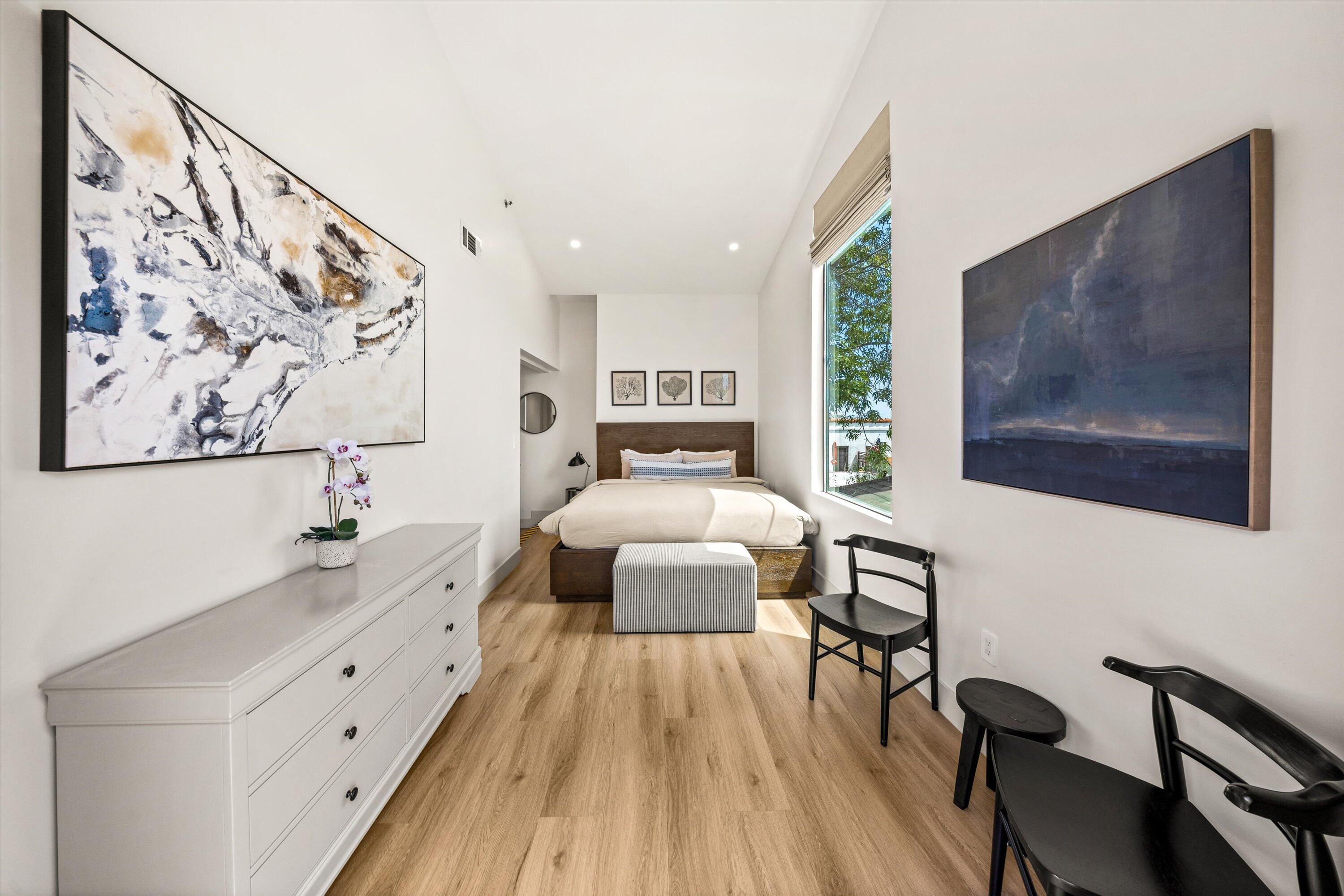 6 East Valerio Street Santa Barbara, CA 93101 - Photo 64 of 74 a bedroom with a large bed and a chandelier