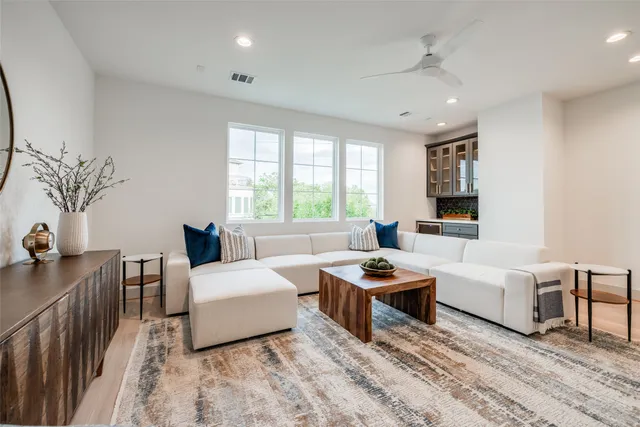 a backyard of a house with chairs plants and wooden fence