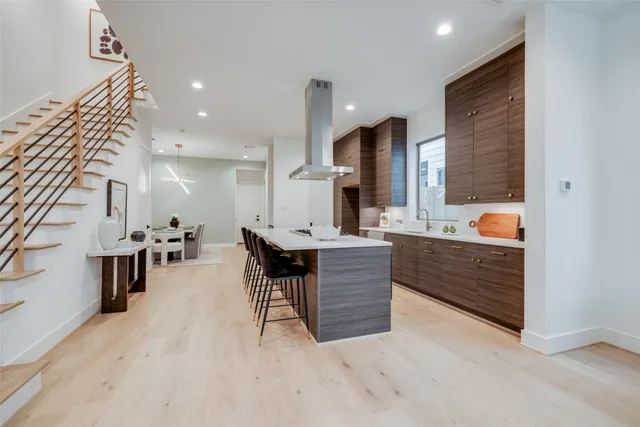 a large kitchen with stainless steel appliances granite countertop a lot of counter space and a sink