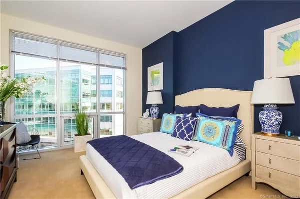 a bedroom with a bed and a lamp on table