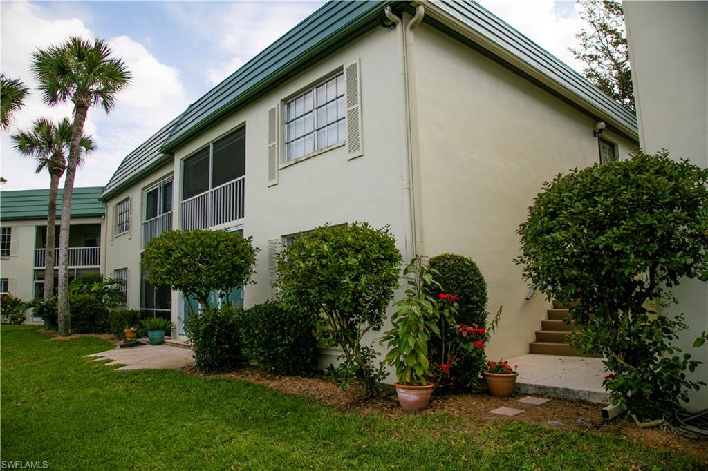 217 Bobolink Way, Unit 217B Naples, FL 34105 - Photo 11 of 17 a front view of a house with garden