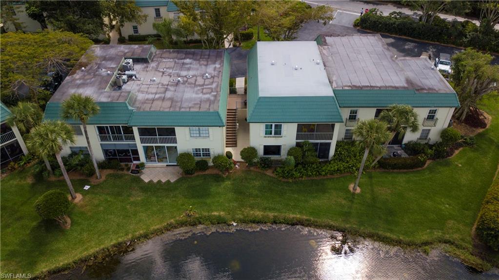 217 Bobolink Way, Unit 217B Naples, FL 34105 - Photo 14 of 17 an aerial view of a house with a yard table and chairs