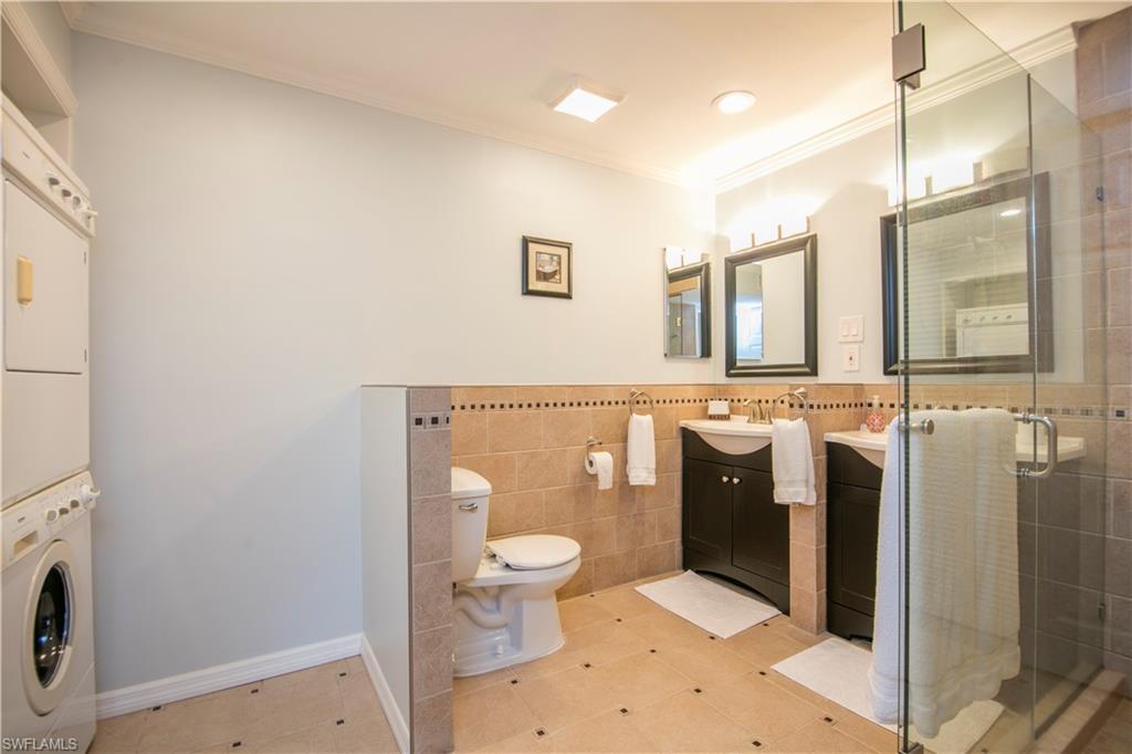 217 Bobolink Way, Unit 217B Naples, FL 34105 - Photo 5 of 17 a bathroom with a toilet sink and mirror