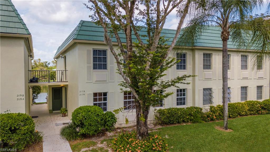 217 Bobolink Way, Unit 217B Naples, FL 34105 - Photo 10 of 17 front view of a house with a yard