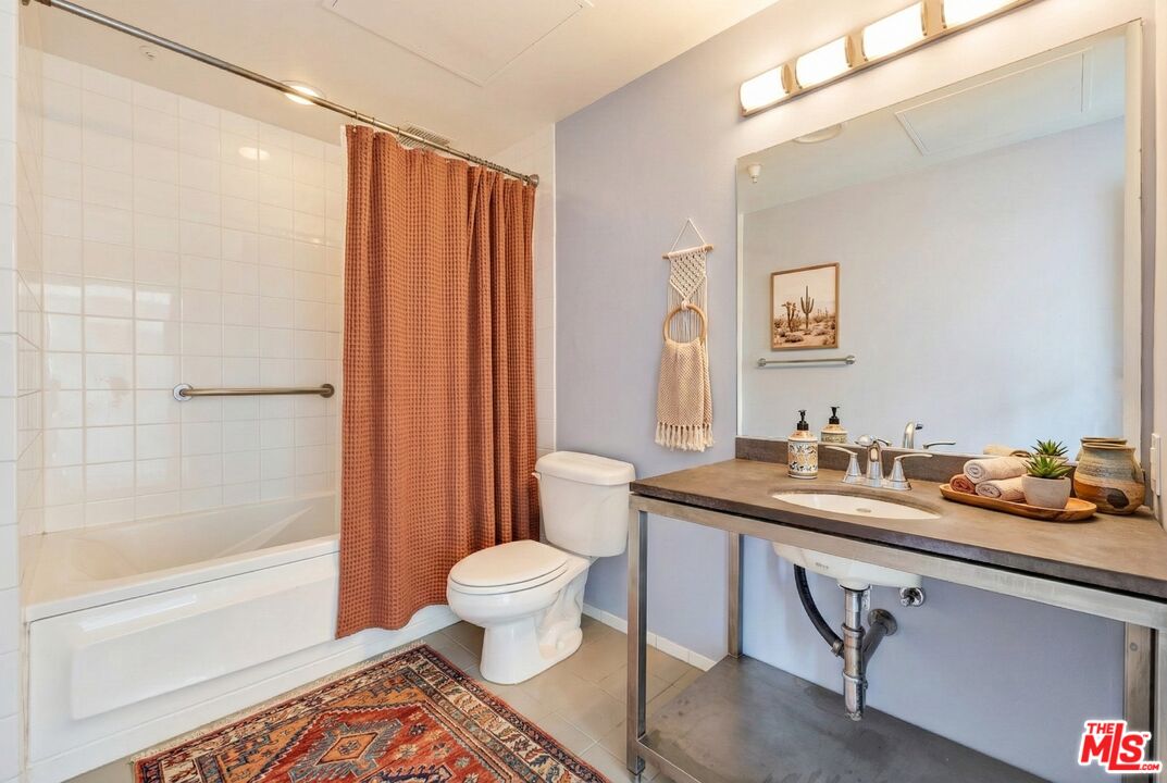 315 East 8th Street, Unit 1102 Los Angeles, CA 90014 - Photo 18 of 34 a bathroom with a sink a toilet and shower