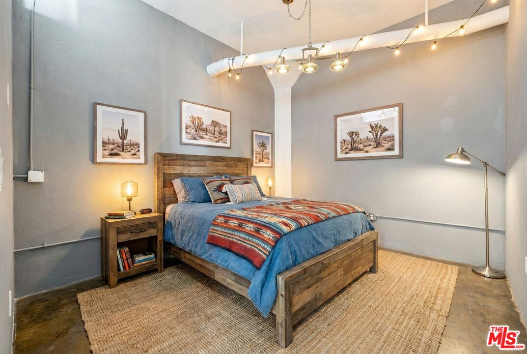 315 East 8th Street, Unit 1102 Los Angeles, CA 90014 - Photo 21 of 34 a bedroom with a bed and a chandelier