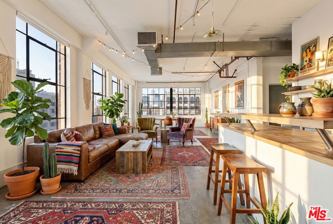 315 East 8th Street, Unit 1102 Los Angeles, CA 90014 - Photo 7 of 34 a living room with lots of furniture and a chandelier