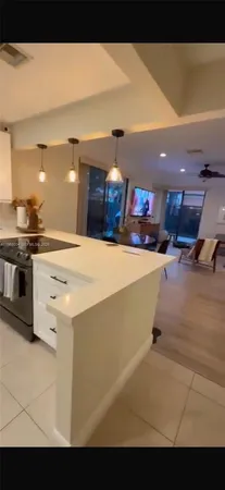 a kitchen with stainless steel appliances kitchen island a stove and a sink