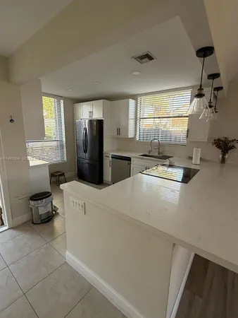 a kitchen with a refrigerator and a stove