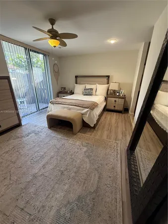a bedroom with a bed and a night stand