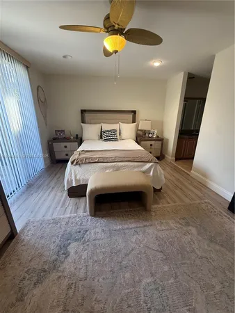 a spacious bedroom with a bed and a chandelier
