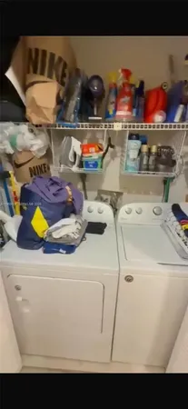 a utility room with a stove and wooden cabinets