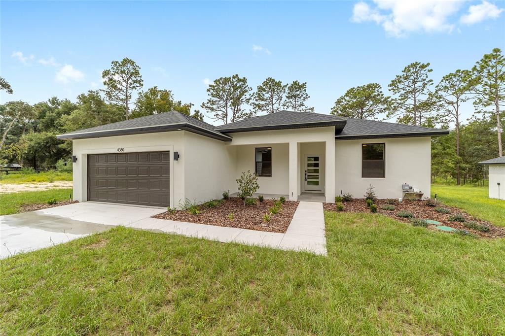 4380 Southwest 159th Court Ocala, FL 34481 - Photo 2 of 44 a house view with a garden space