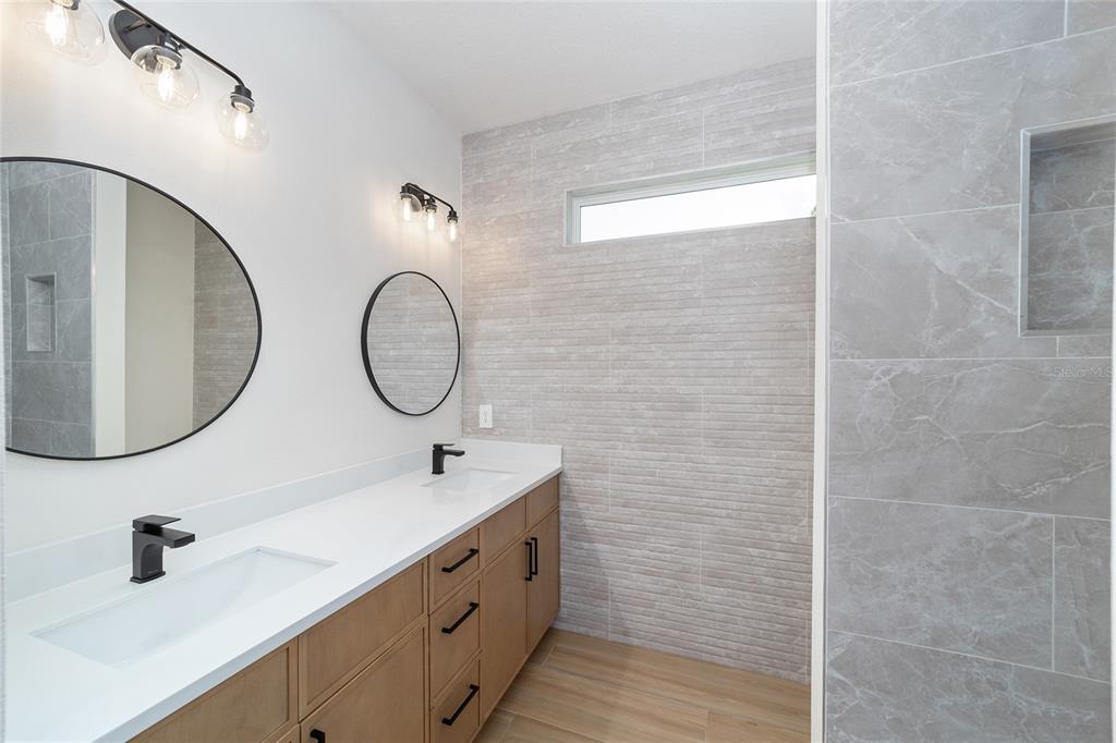 4380 Southwest 159th Court Ocala, FL 34481 - Photo 25 of 44 a bathroom with a double vanity sink mirror and shower