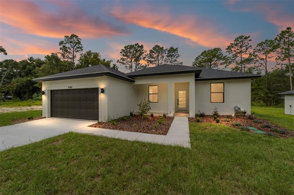 4380 Southwest 159th Court Ocala, FL 34481 - Photo 44 of 44 a front view of a house with a yard and garage