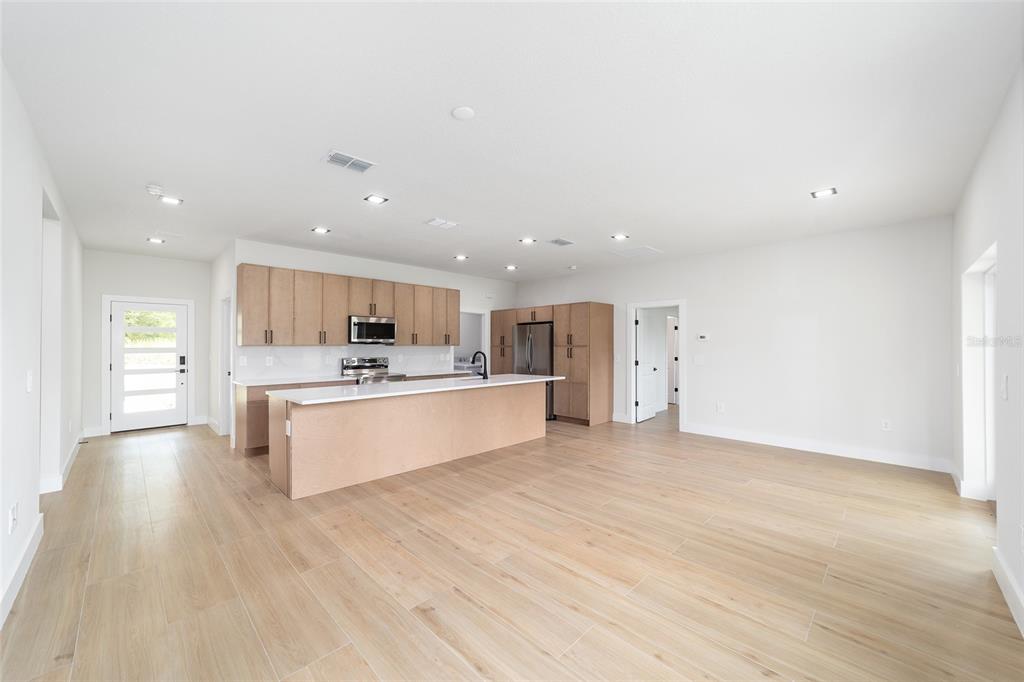 4380 Southwest 159th Court Ocala, FL 34481 - Photo 7 of 44 a large kitchen with a lot of counter space and a refrigerator