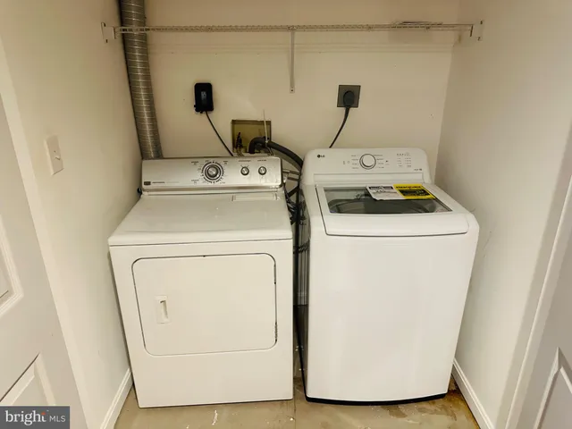 a view of swimming pool with a chair and floor to ceiling window
