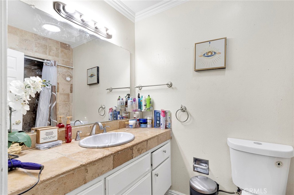 1087 Baseline Road La Verne, CA 91750 - Photo 17 of 39 a bathroom with a granite countertop sink vanity mirror and toilet