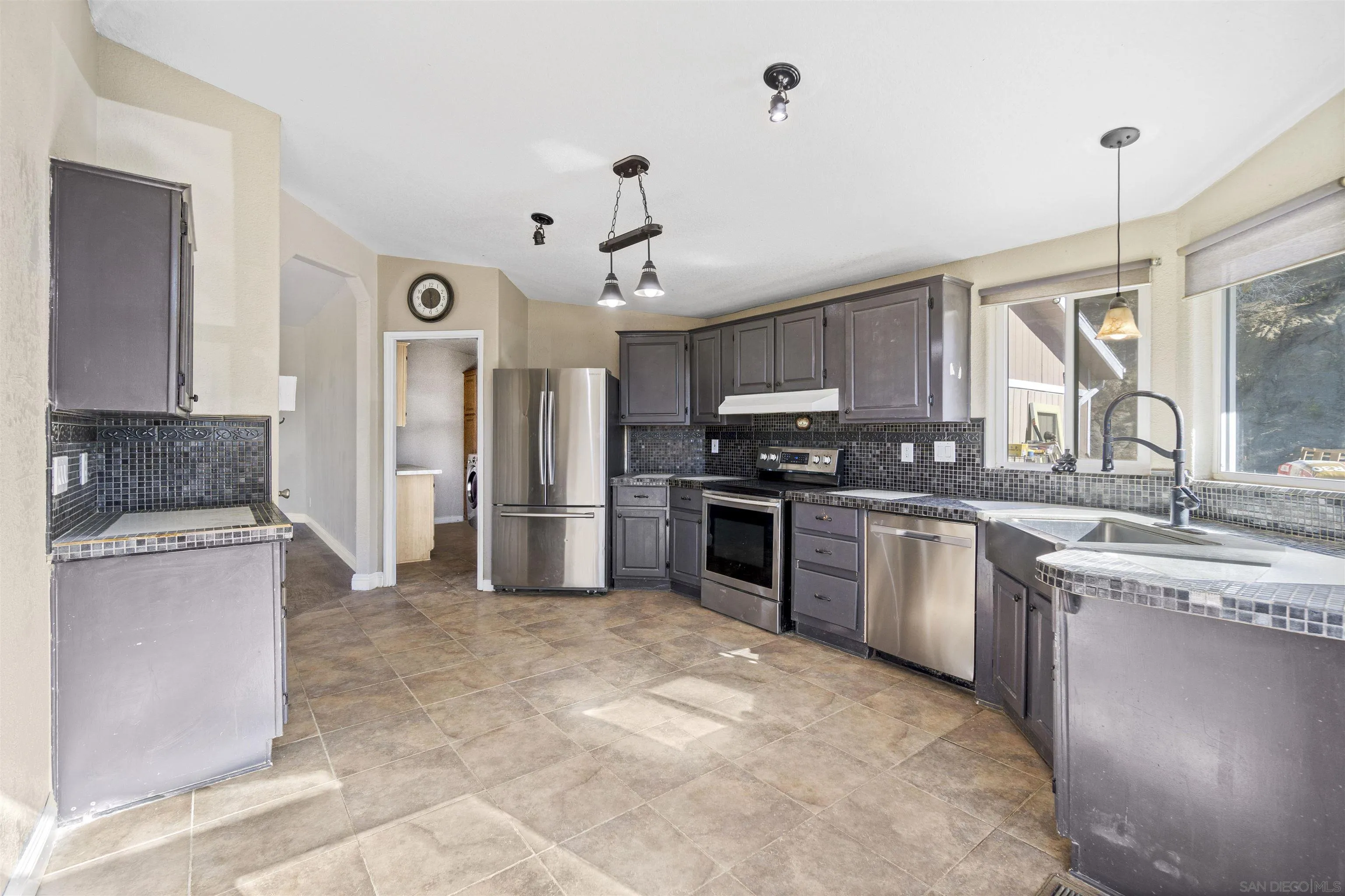 5631 Alpine Boulevard Alpine, CA 91901 - Photo 11 of 20 a kitchen with stainless steel appliances granite countertop a stove top oven a sink a refrigerator and a granite counter tops