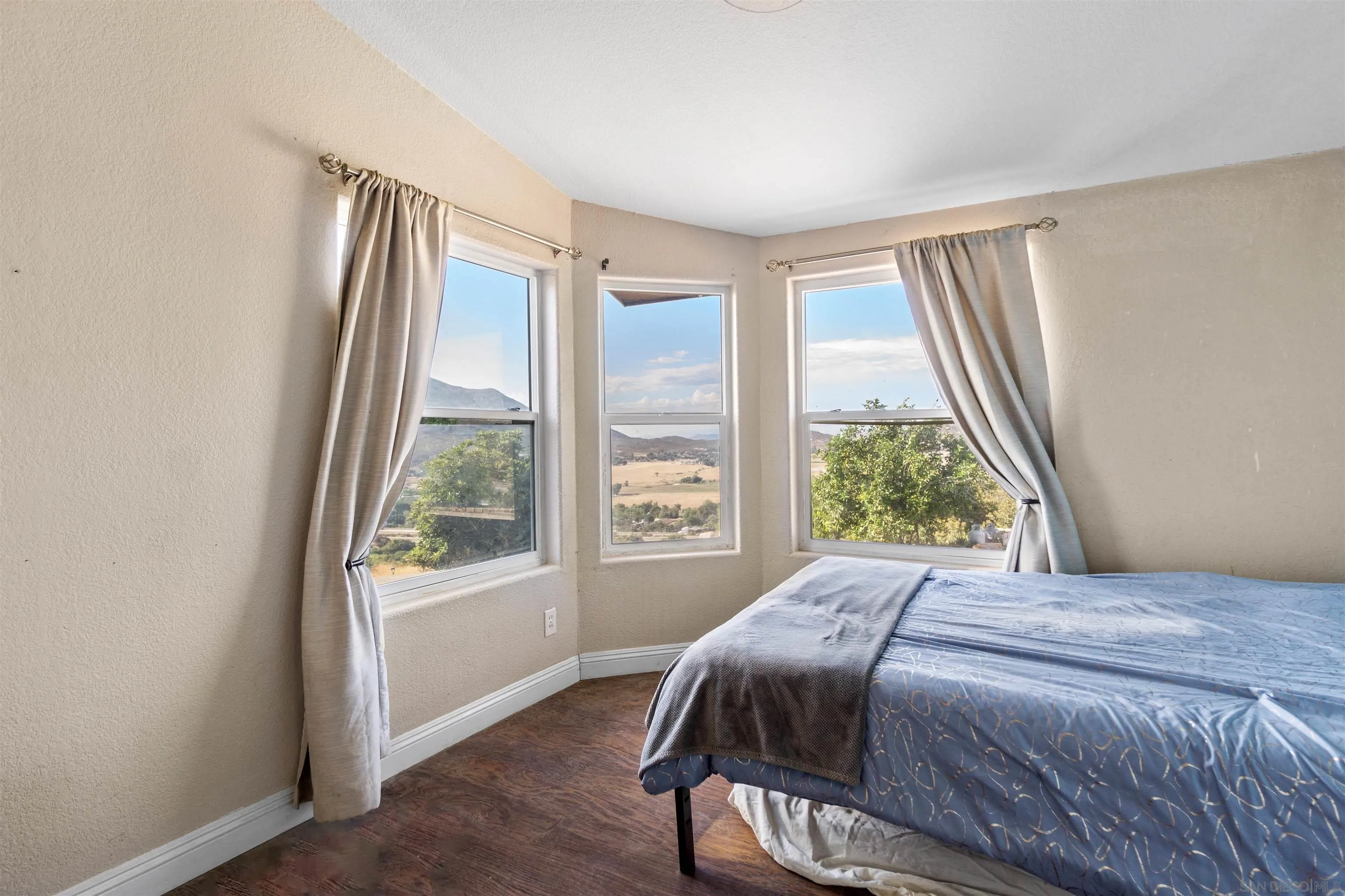 5631 Alpine Boulevard Alpine, CA 91901 - Photo 16 of 20 a bedroom with a bed and a large window